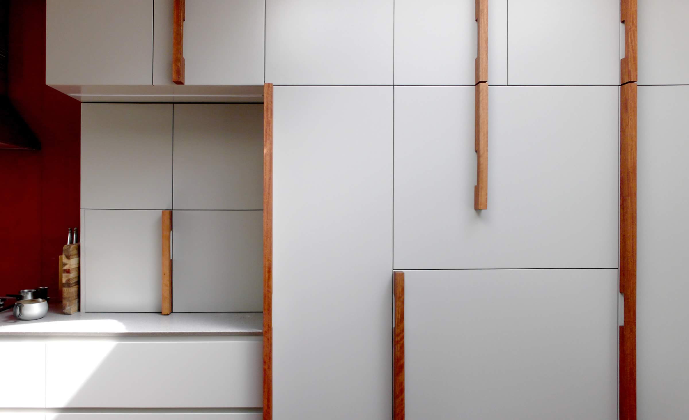 Customised kitchen joinery incorporating one-off design spotted gum timber handles.